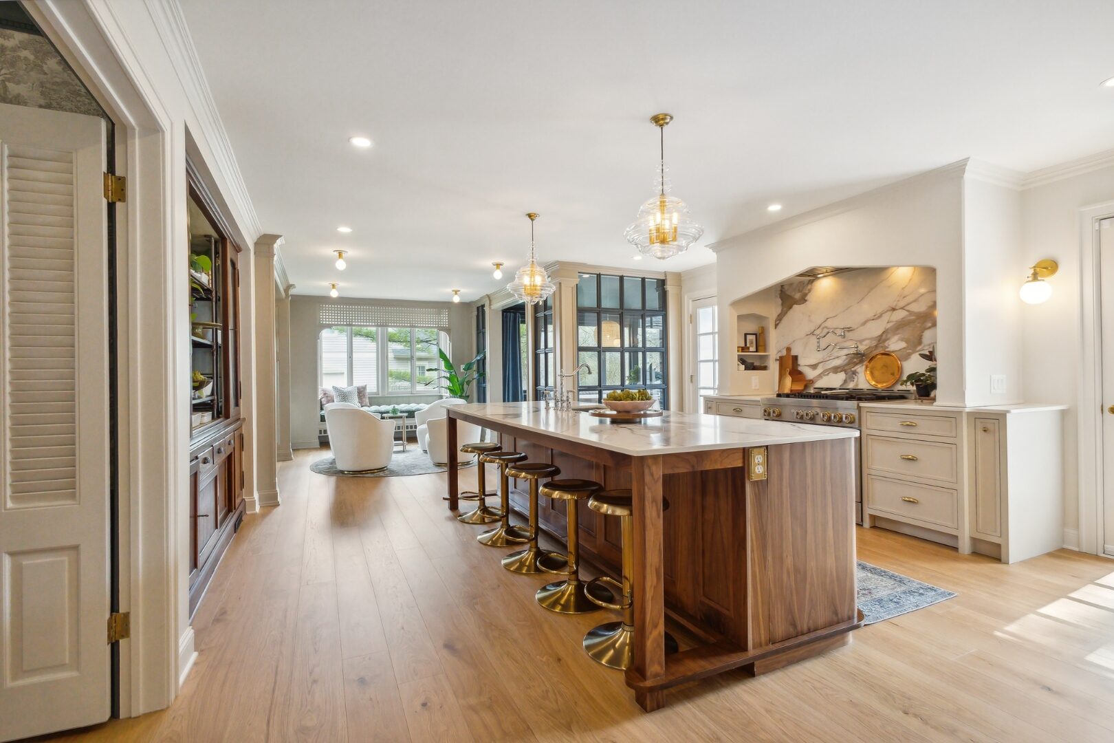 Editorial kitchen interior. Warm pendant light over a marble island. Aurora, Ohio.